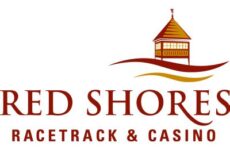 Red Shores Racetrack & Casino logo with a stylized orange-roofed building atop waves and the text 'RED SHORES RACETRACK & CASINO' in maroon.