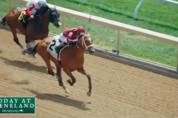 Two jockeys ride galloping horses on a dirt race track, Keeneland signage visible on the in-frame logo at the bottom left.