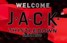 Welcome JACK Thistledown Racino banner on a red, geometric background with small card suit icons—promotional casino branding.